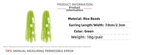 Detail of green handmade beaded tassel earrings with white flowers, size 7.0cm x 2.3cm