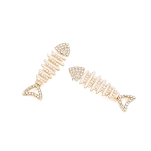Detail of fishbone earrings with pearls and rhinestones on gold alloy base