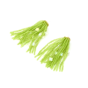 Detailed view of light green beaded tassel earrings with iridescent flower sequins