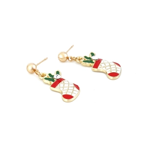 Macro detail of Christmas stocking earrings with red white enamel and sparkling crystal