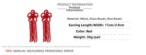 Detailed view of red beaded flower tassel earrings with size dimensions 11cm by 3.9cm