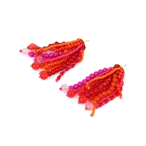 Detail of bohemian handmade beaded fringe earrings with vibrant multi-colored tassels