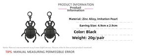 Detail of black enamel beetle earrings showing 4.9cm x 2.9cm size and pearl accents