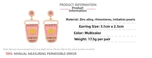 Detail view of pink juice cup earrings with rhinestones, pearls and size dimensions