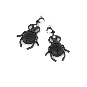 Vintage matte black beetle earrings with pearl-like beads on a clean white background