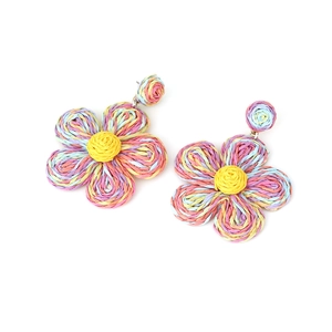 Close-up of handmade bohemian raffia flower earrings with colorful woven petal details