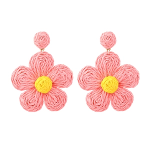 Handmade raffia flower earrings in pink and yellow for a bohemian summer look
