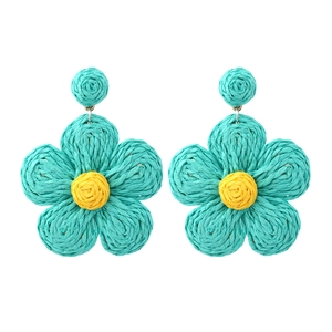 Handmade raffia flower earrings in bohemian style with blue petals and yellow center