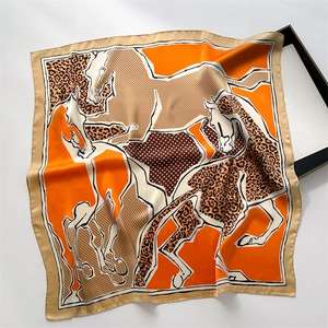 Detailed view of the leopard and horse print square scarf with elegant silk texture