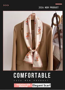 Stylishly tied silk-feel scarf with persimmon print on a camel blazer lapel