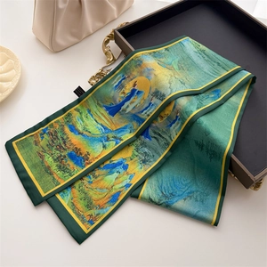 Detailed view of long silk scarf with traditional landscape print on a display tray