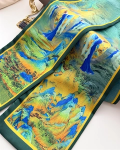 Close-up of silk scarf with landscape print, dark green fabric and yellow edging