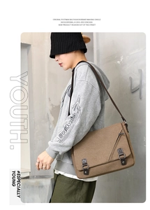 Brown canvas messenger bag detail showing high-density fabric and leather buckle accents