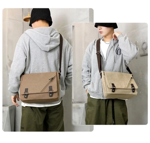 Detailed close-up of brown and beige canvas messenger bags featuring double buckle flaps