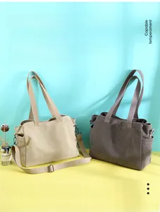 Detail view of large canvas tote bag showing side pockets and detachable straps