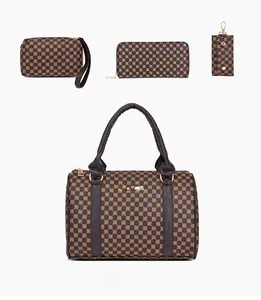 Detail of four-piece handbag set featuring printed cylinder bag and matching accessories