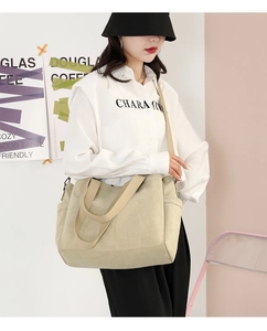 Detail view of large canvas tote bag with side pocket and comfortable shoulder strap