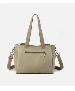 Detailed front view of olive green canvas tote bag with zipper pocket and shoulder strap