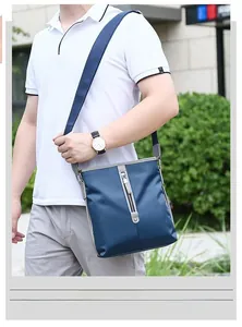 Navy blue Oxford fabric crossbody bag shown on model for casual outdoor travel use