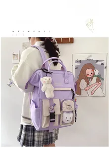 Close-up of lavender nylon school backpack with bear pendant and stylish patch details