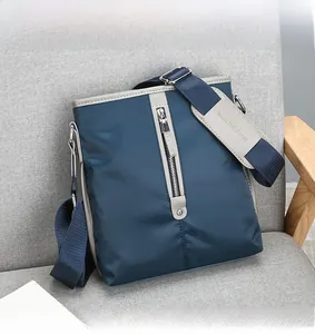 Detailed close-up of dark blue nylon business bag with shoulder strap padding