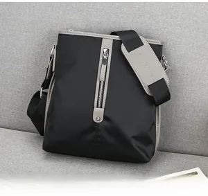 Close-up of waterproof black oxford fabric shoulder bag with metal zipper and padded strap