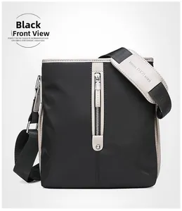 Detail of black Oxford fabric shoulder bag with beige leather trim and brand logo