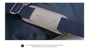 Detail of oxford fabric shoulder strap featuring a grey leather padded shoulder cushion