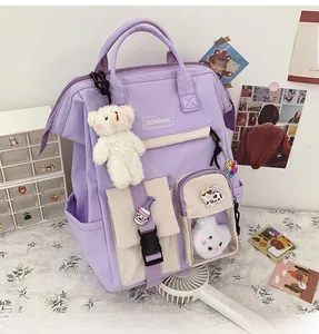 Close-up of a lavender school backpack with cute bear pendant and decorative badges