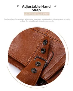 Detail of adjustable brown leather handle with matte gunmetal buckles and lychee texture