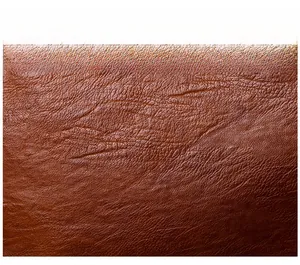 Macro shot of soft brown leather fabric with clear lychee texture and flexible feel