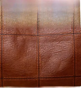 Close-up of brown textured leather with orange grid stitching and litchi grain detail