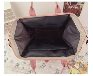 Detail showing the spacious pink backpack interior with multiple pockets and lining