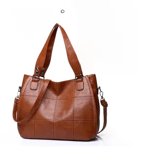 Detail of vintage brown tote bag showing the anti-theft back pocket and quilted leather texture