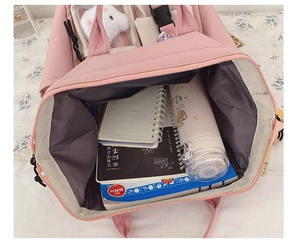 Top view showing large capacity of pink school backpack with books and water bottle