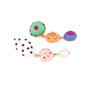 Detailed view of asymmetric drop earrings with colorful resin shapes and rhinestones