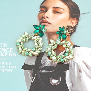Vintage hollow flower hoop earrings with green rhinestones and gold alloy plating