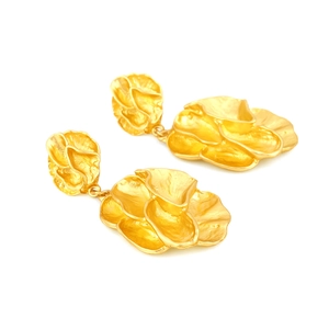 Exaggerated vintage gold flower drop earrings with textured metal petals on white background
