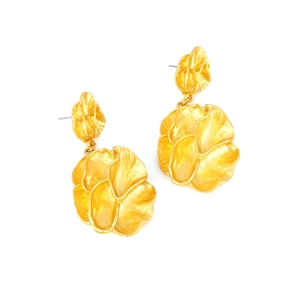 Detail of matte gold flower earrings featuring layered petals and brushed metal texture