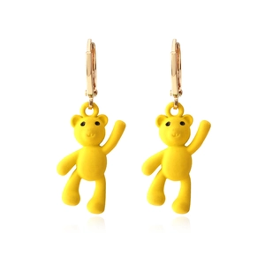 Fashionable yellow bear drop earrings with golden leverback closures on white background