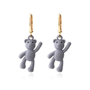 Creative gray matte teddy bear earrings with gold hoops in a clean front view