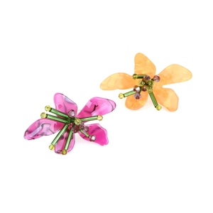 Detailed macro view of acrylic resin flower rings with colorful beaded stamens