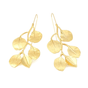 Retro long gold leaf drop earrings with vintage metallic texture on white background