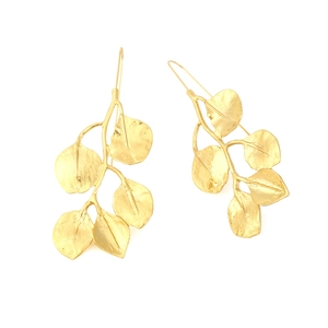 Macro detail of golden leaf earrings with realistic textured leaf patterns and ear hook
