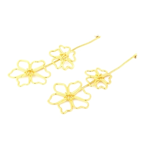 Detailed macro view of long gold alloy floral earrings with elegant snake chains