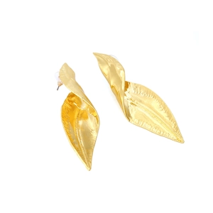 Detailed close-up of gold-plated leaf earrings with textured twisted metal design