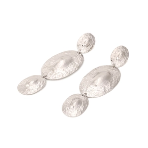 Detailed view of silver hammered texture on three-tier oval metal drop earrings