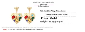 Detailed view of large gold heart earrings with rhinestones showing dimensions and weight