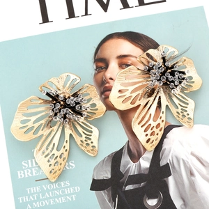 Exaggerated golden beaded flower earrings with intricate brushed petals and crystal centers