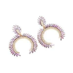 Macro detail of geometric C-shaped earrings with purple and AB marquise crystals